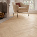 Detailed view of Bardolino White engineered herringbone plank showing the subtle whitewashed oak texture and clean bevel edges.