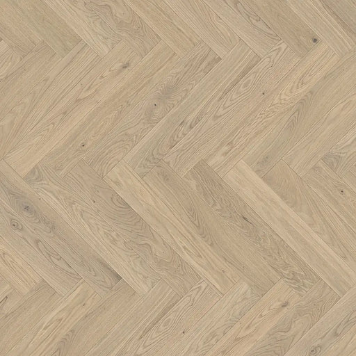 Detailed view of Bardolino White engineered herringbone plank showing the subtle whitewashed oak texture and clean bevel edges.