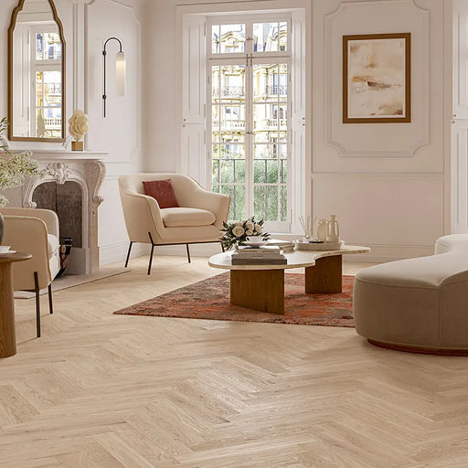 Bardolino White Herringbone flooring in a sunlit room with light wood furniture.