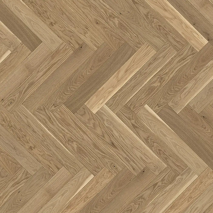 Detail of Trendtime 3 Cream Herringbone flooring showing the light oak finish, fine grain pattern, and precise parquet layout.