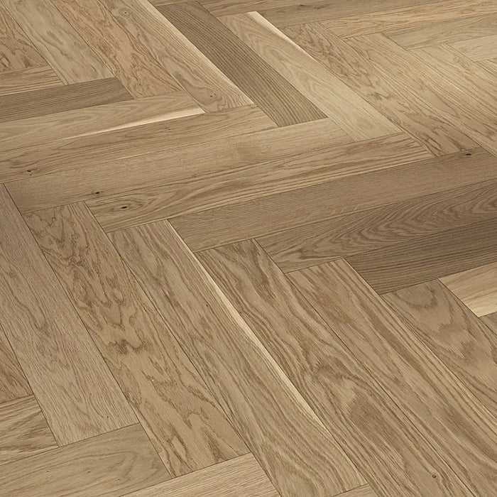 Detail of Trendtime 3 Cream Herringbone flooring showing the light oak finish, fine grain pattern, and precise parquet layout.