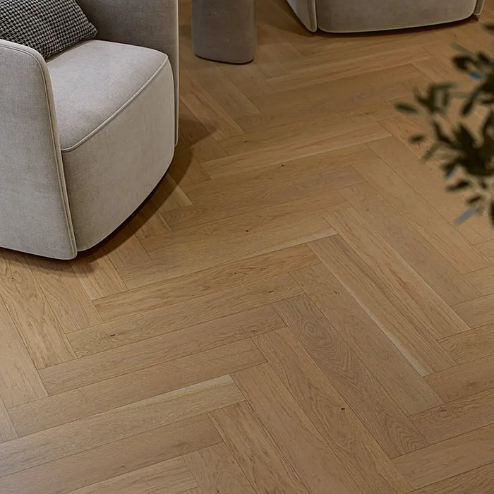 Trendtime 3 Nougat Herringbone flooring in a bright reading nook with an armchair.