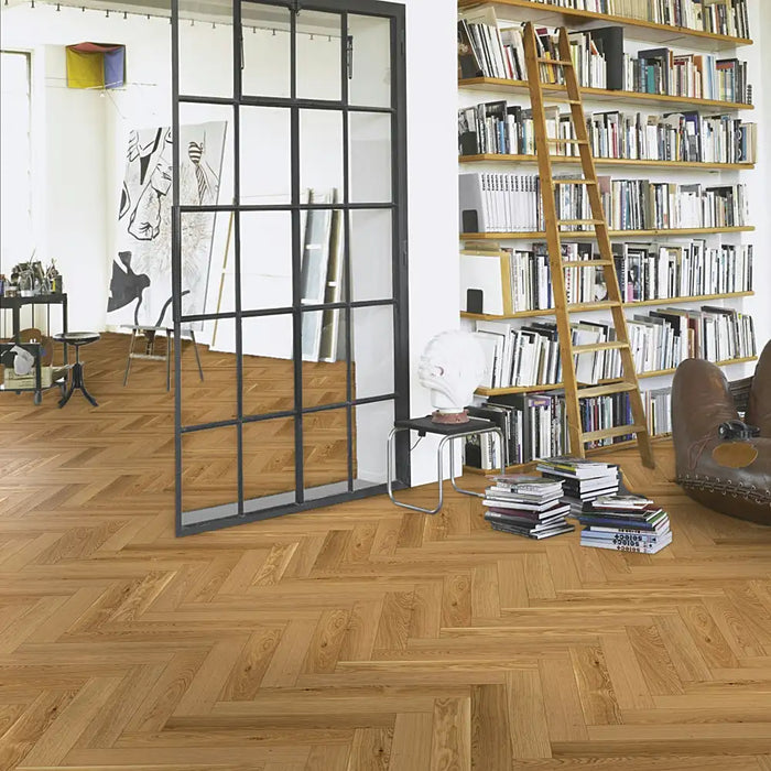 Trendtime 3 Oak Herringbone flooring in a sophisticated living room with contemporary furnishings, and neutral décor.
