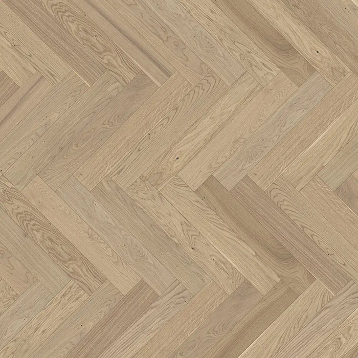 Close-up of Trendtime 3 Pure Herringbone flooring showing clean oak grain, subtle texture, and smooth matt lacquer finish.