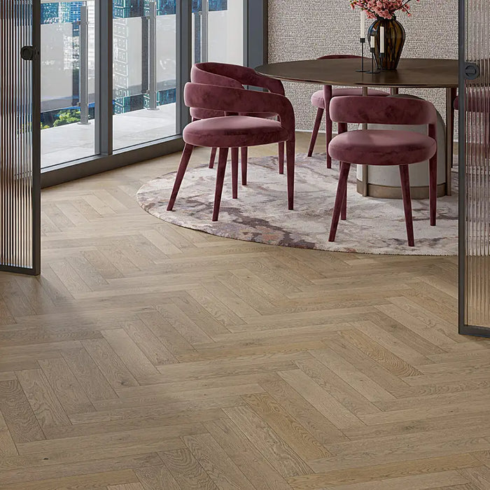 Close-up of Chalet Grey engineered herringbone plank showing a softly brushed grain with cool-toned grey variation and matt lacquer finish.