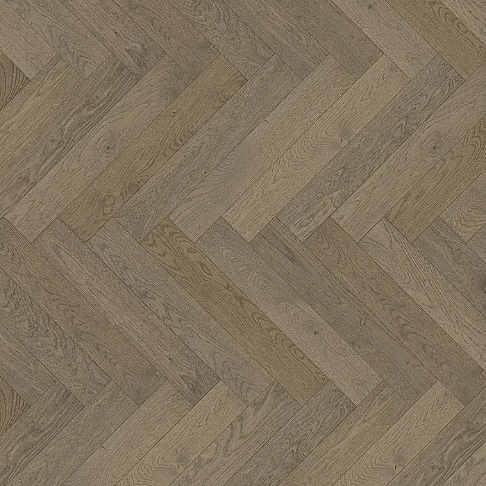 Close-up of Chalet Grey engineered herringbone plank showing a softly brushed grain with cool-toned grey variation and matt lacquer finish.