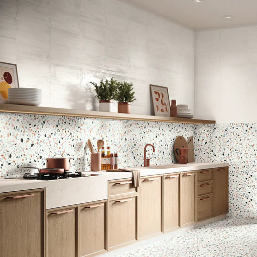 A kitchen backsplash finished with Trendy Mix wall tiles, showing a colourful patterned design.