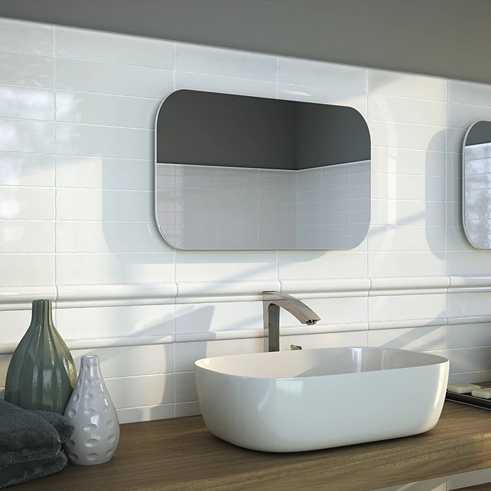 A bathroom wall styled with Vintage White wall tiles, giving a bright and rustic-inspired look.