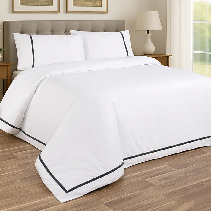 White and dark grey faux velvet duvet set styled on a bed, featuring sateen cotton with soft velvet trim.