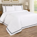 White and dark grey faux velvet duvet set styled on a bed, featuring sateen cotton with soft velvet trim.