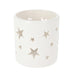 Close-up of white tealight holder showing small star perforations and smooth porcelain finish.