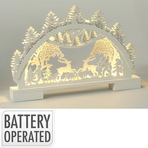 Close-up of woodland Christmas scenery showing detailed trees and softly lit LED scene.