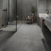 Sleek bathroom with Work B Coal Anti-Slip Porcelain tiles in a deep charcoal tone.