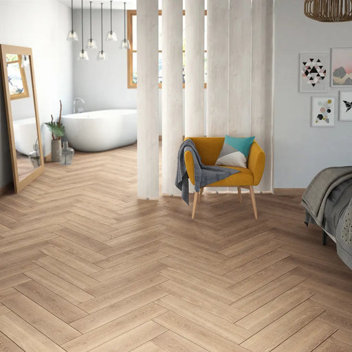Alicante herringbone laminate flooring in a bedroom with a room divider and armchair