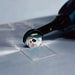 Bihui Mini Angle Grinder cutting a square opening in a tile