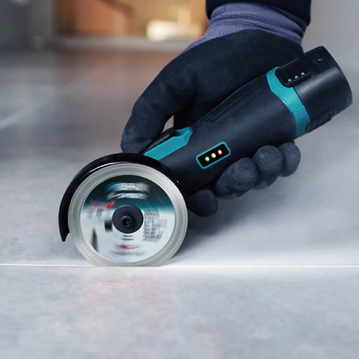 Bihui Mini Cordless Angle Grinder cutting a straight line in a floor tile