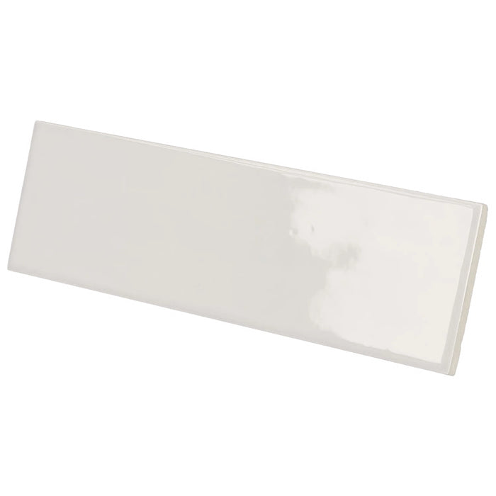 Country Gris Claro gloss wall tile in a soft light grey colour with a slim brick format, shown at an angle.