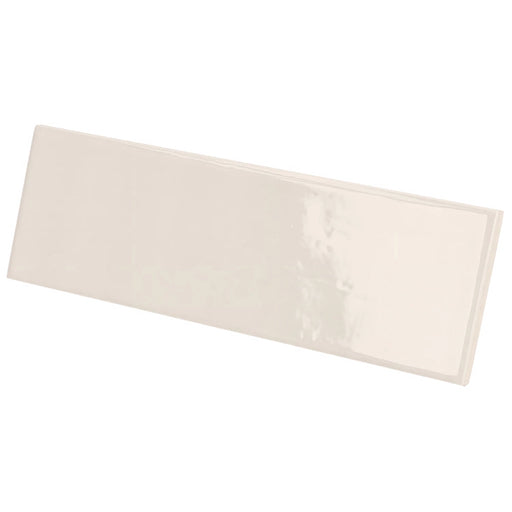 Country Ivory gloss wall tile in a soft ivory colour with a slim brick format, shown at an angle.