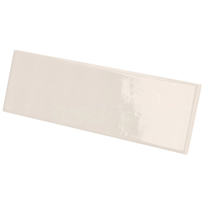 Country Ivory gloss wall tile in a soft ivory colour with a slim brick format, shown at an angle.
