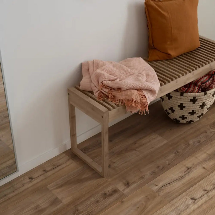 Pergo Drammen Brown laminate flooring in a hallway setting with a wooden bench