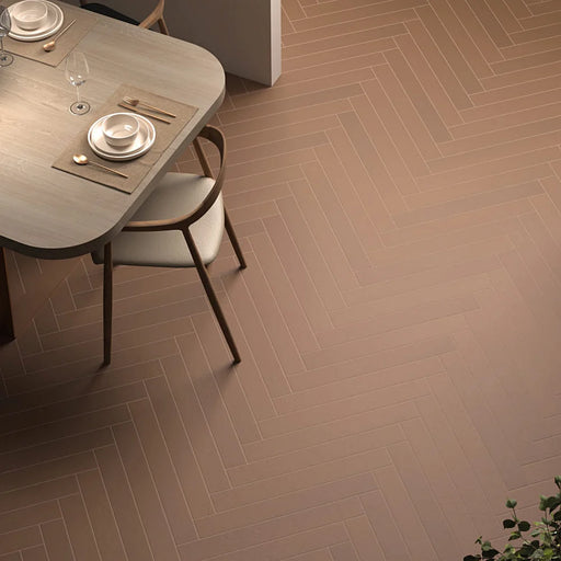 Earth Baltic Amber porcelain tiles installed in a herringbone floor pattern with warm wood furniture and modern interior décor.
