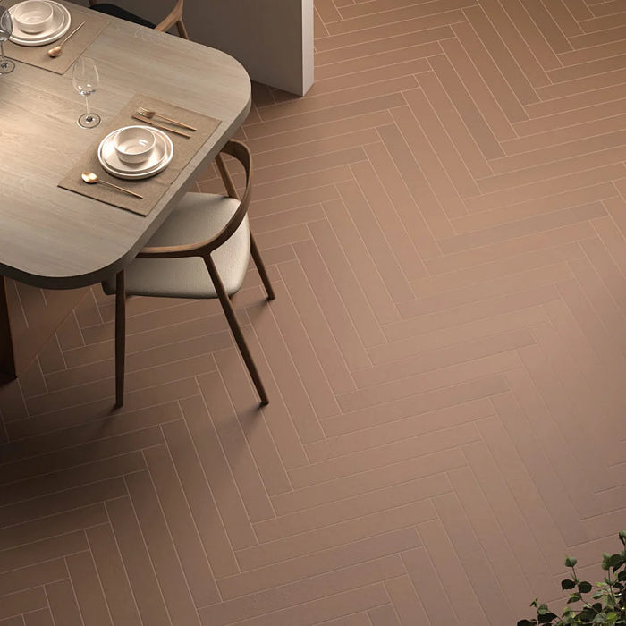Earth Baltic Amber porcelain tiles installed in a herringbone floor pattern with warm wood furniture and modern interior décor.