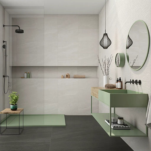 Modern bathroom featuring Eddystone Blanco matt wall tiles with black shower fittings and sage green vanity