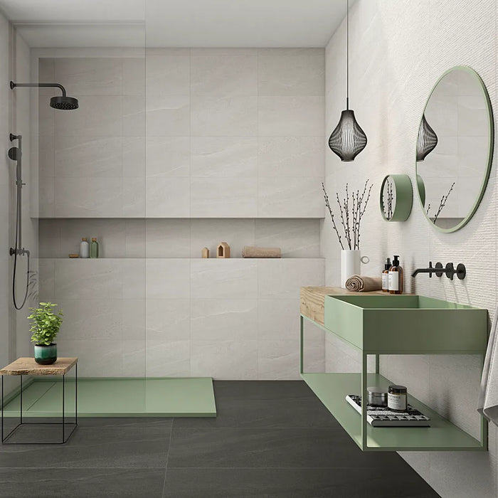 Modern bathroom featuring Eddystone Blanco matt wall tiles with black shower fittings and sage green vanity