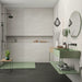 Modern bathroom featuring Eddystone Blanco matt wall tiles with black shower fittings and sage green vanity