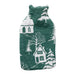 Green knitted hot water bottle cover with a white snowy village and pine tree design