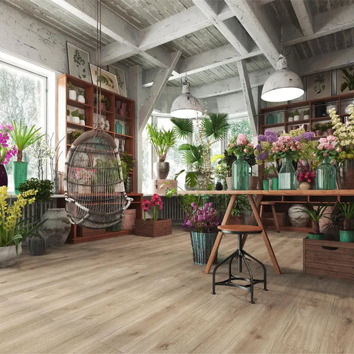 Krono Venice Oak long plank laminate flooring in a plant-filled florist studio setting