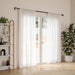 Loop matt black curtain pole with curtain in a living room setting