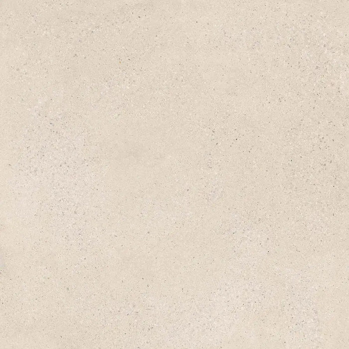 Close-up fine stone fleck texture detail of Memory Marfil porcelain tile