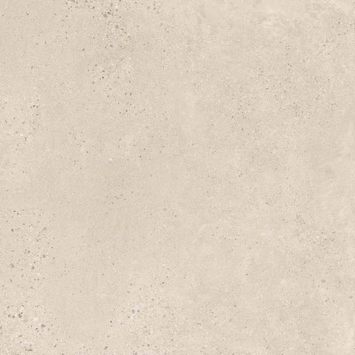 Close-up speckled concrete-effect surface detail of Memory Marfil porcelain tile