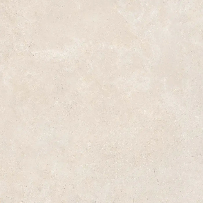 Close-up natural stone texture detail of Montpellier Marfil porcelain tile
