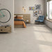 Montpellier Marfil porcelain tile floor in a bedroom setting