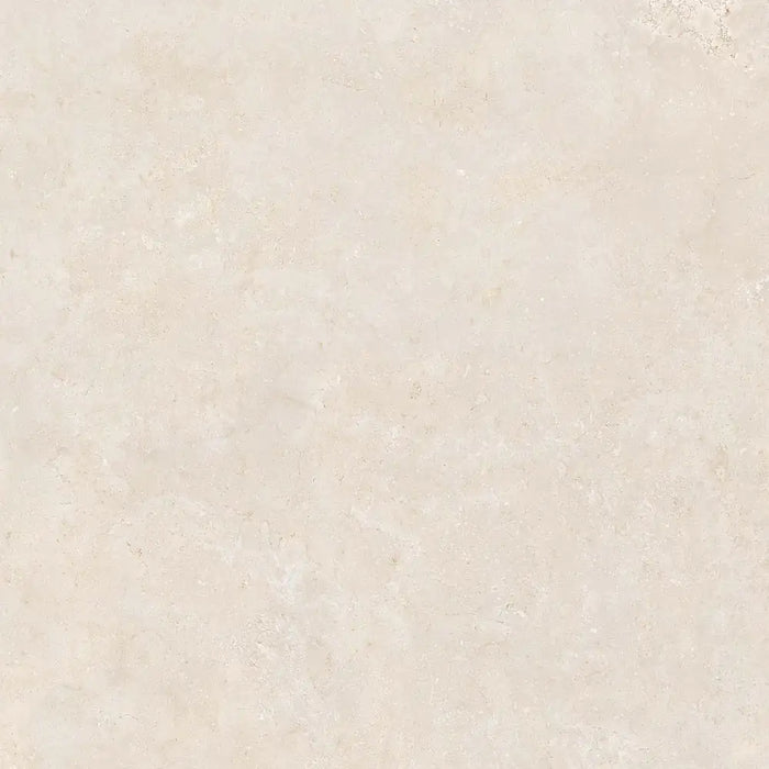 Close-up limestone-effect surface detail of Montpellier Marfil porcelain tile