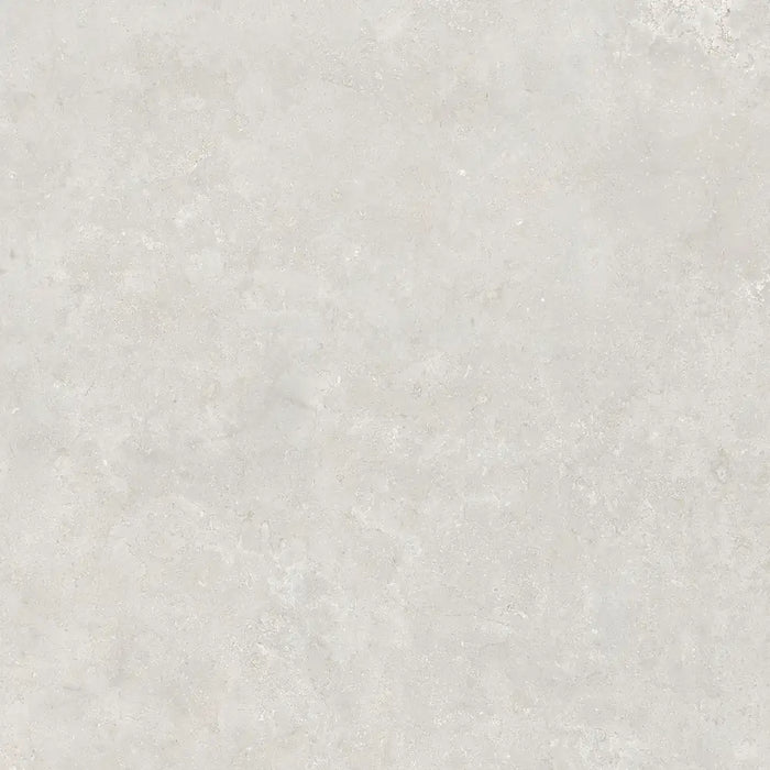 Close-up limestone-effect surface detail of Montpellier Perla porcelain tile