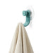 	Nami adhesive hook in ocean blue colour holding a cream towel
