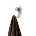 Nami adhesive hook in sand colour holding a brown towel