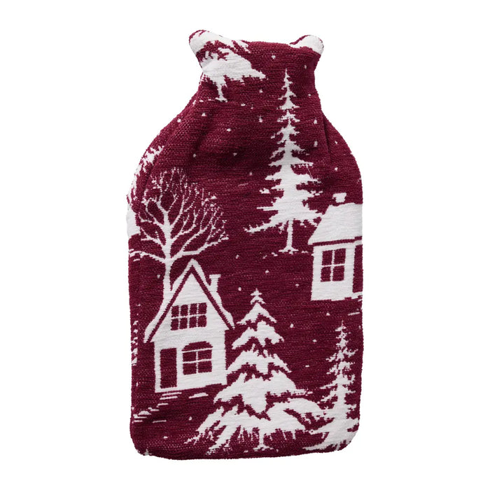 Red knitted hot water bottle cover with a white snowy village, cottage and pine tree design