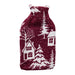 Red knitted hot water bottle cover with a white snowy village, cottage and pine tree design