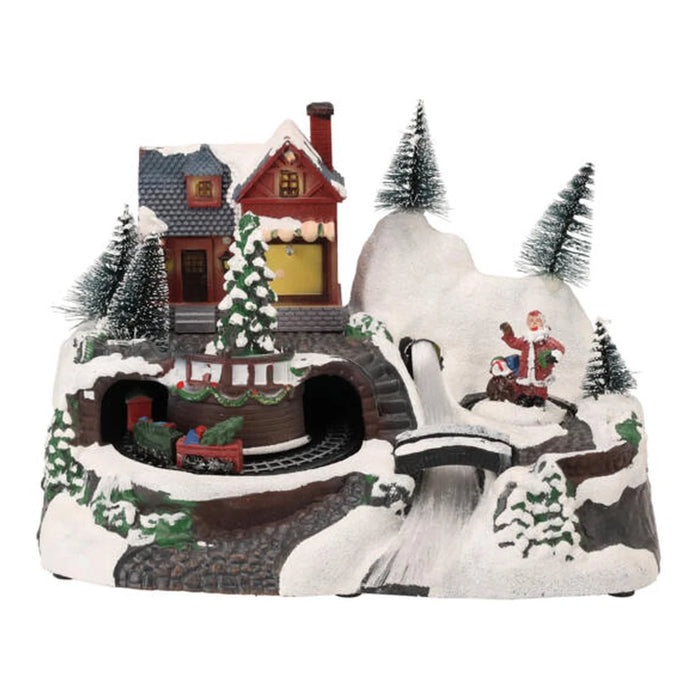 Snowy hillside Christmas scene with a red house, tunnels, a bridge and bottle brush trees