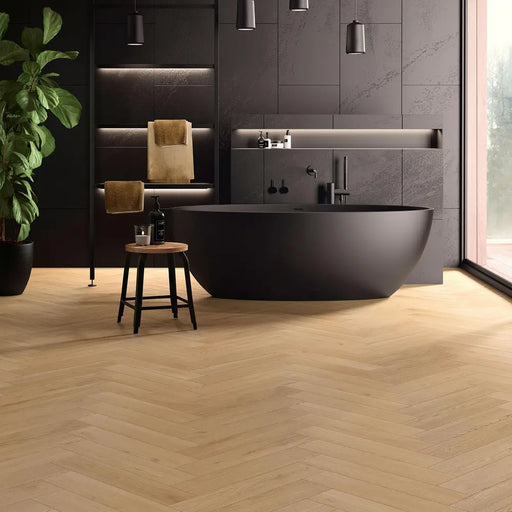 Sedona herringbone laminate flooring in a modern bathroom with a freestanding tub