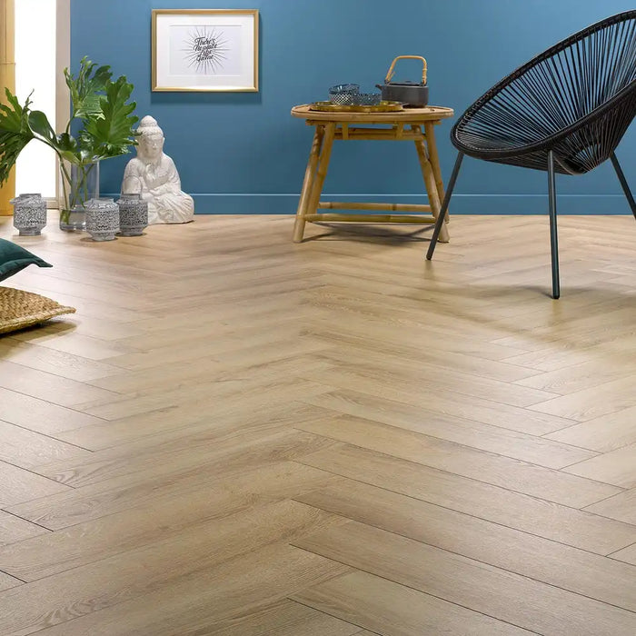 Shannon herringbone laminate flooring in a bright living room with blue accent wall