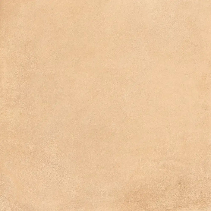 Close-up sandy stone-effect surface detail of Terracota Paja porcelain tile