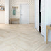 Vicence herringbone laminate flooring in a hallway with chevron wallpaper