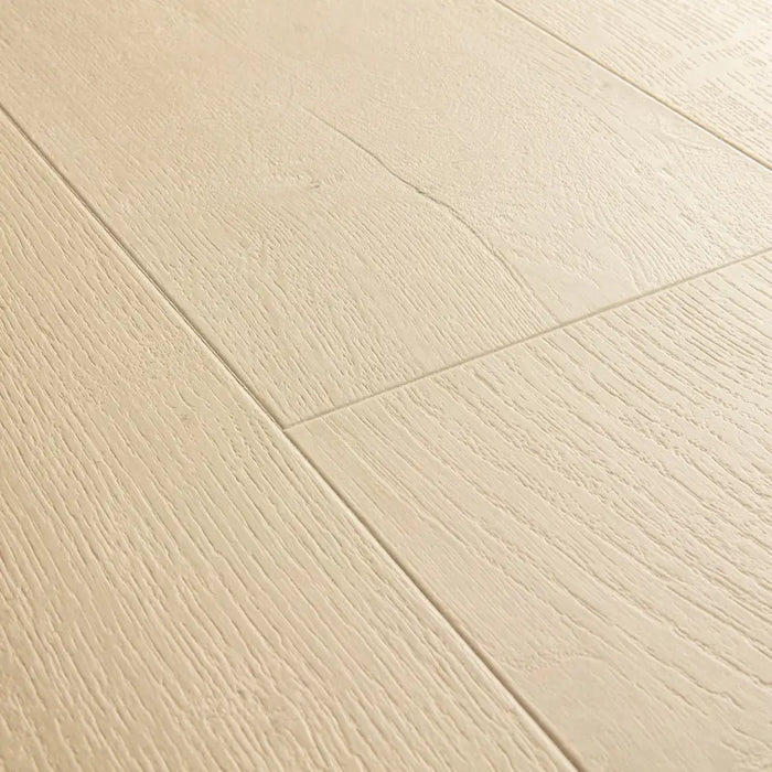 Angled close-up of Pergo Visby Beige oak laminate flooring grain and bevel
