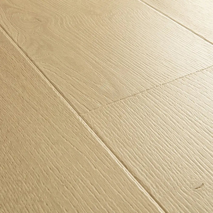 Angled close-up of Pergo Visby Sand Drift oak laminate flooring grain and bevel