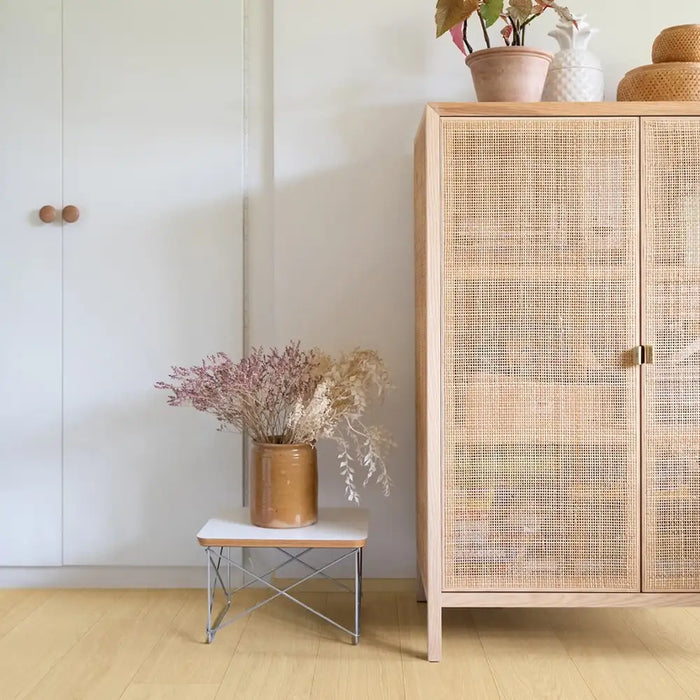 Pergo Visby Sunwash laminate flooring beside a rattan cabinet